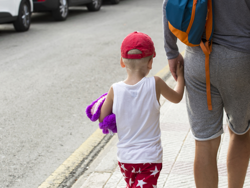 Child with a toy on the street